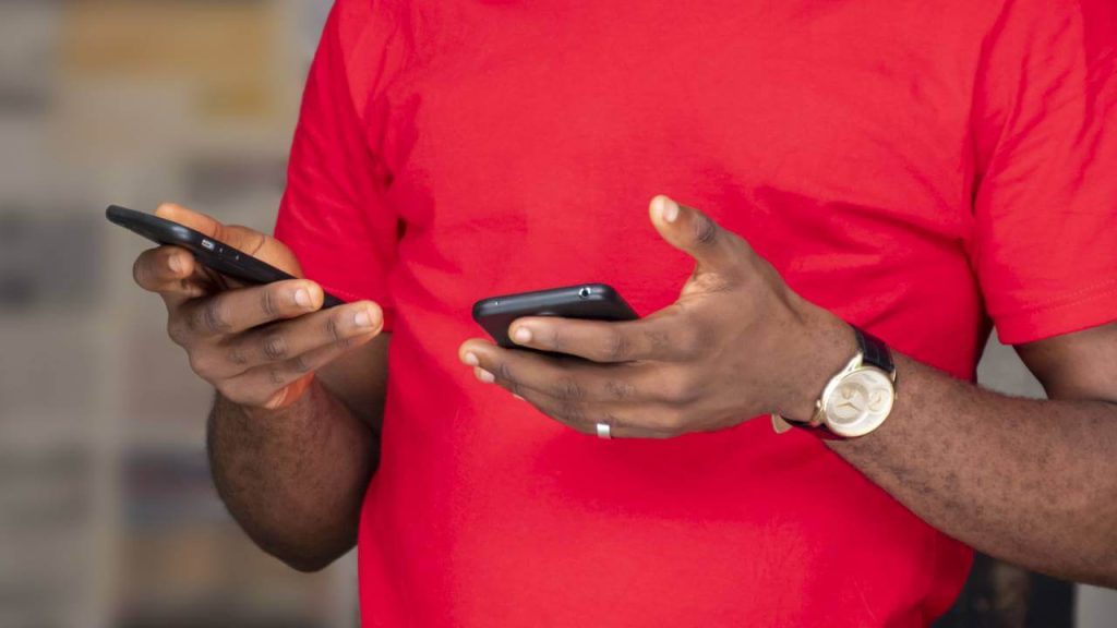 Nigerian user holding smartphones data surge MTN Airtel 2025