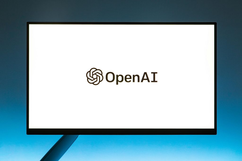 Selected thumbnail showing the OpenAI logo on a computer screen inside a media upload window